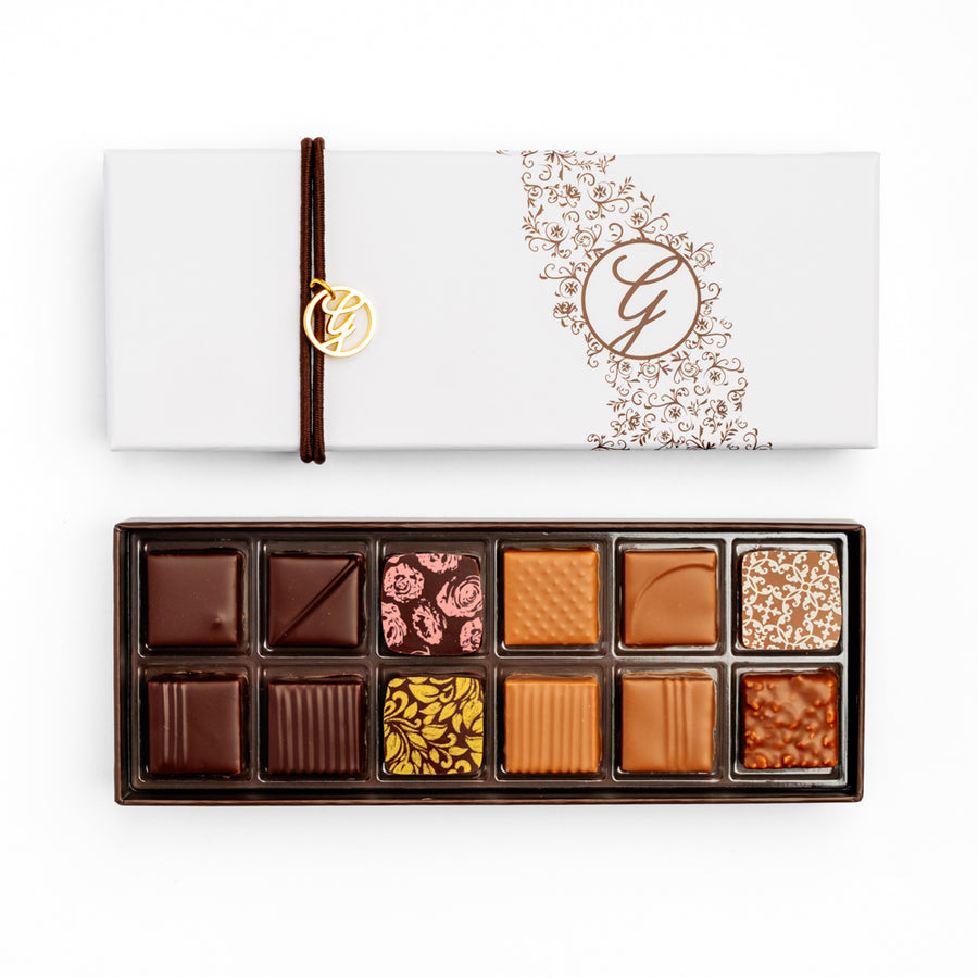 open 12-piece chocolate box arranged below closed box on white background