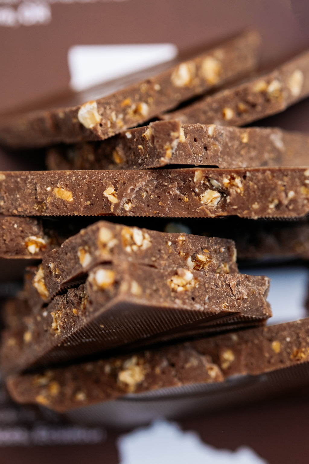 Close-up of chocolate bars with nuts and a dark background