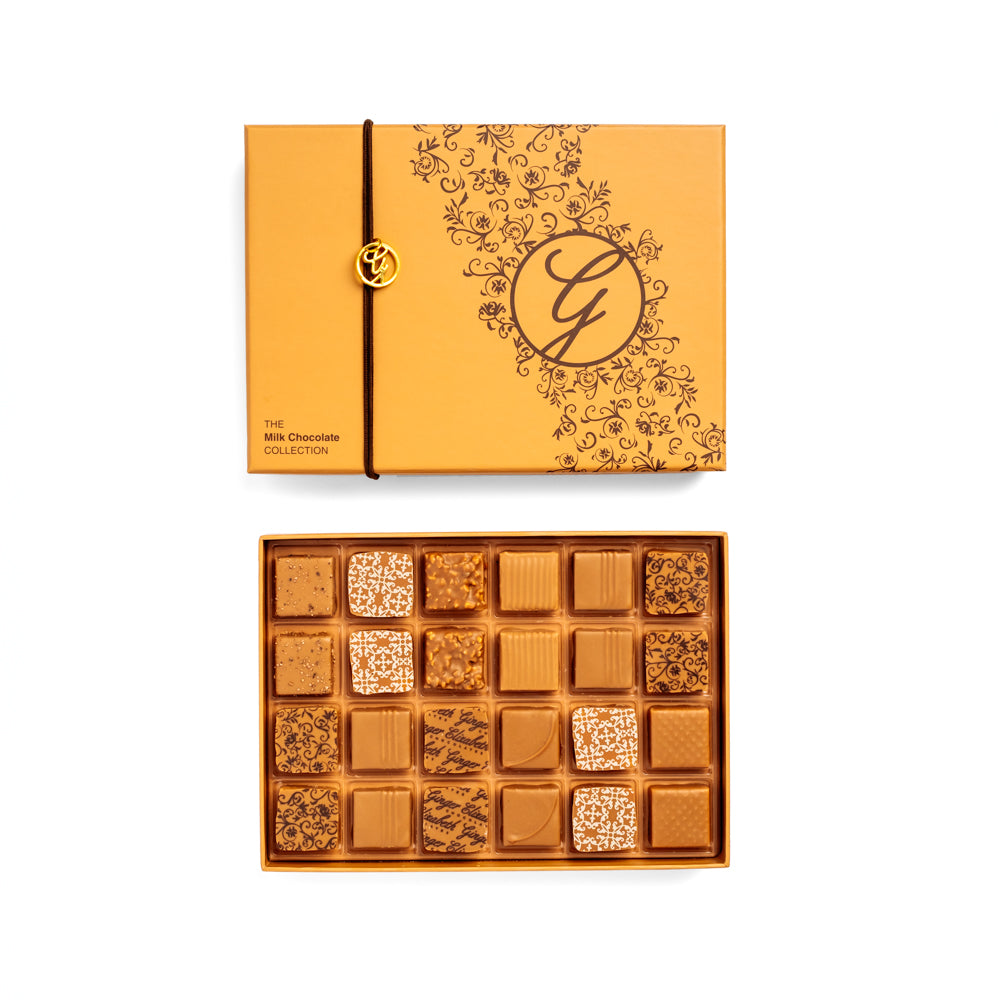 open 24-piece box of dark chocolate bonbons arranged under closed box on white background