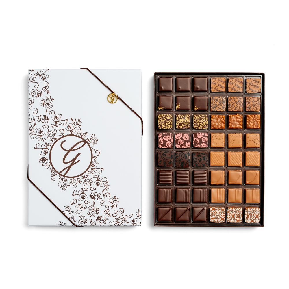 open 48-piece chocolate box arranged below closed box on white background