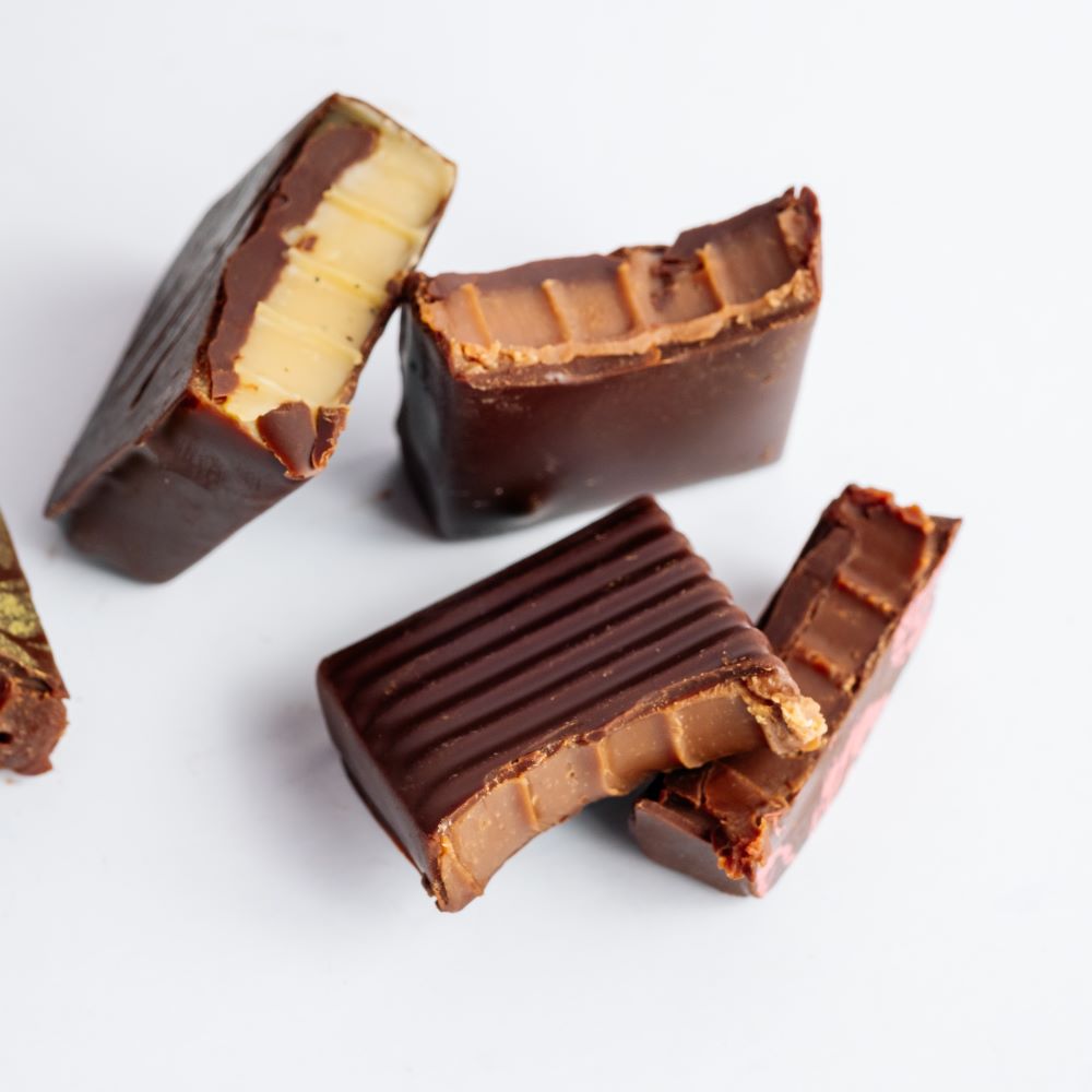 close up of dark chocolates showing interior on whte background